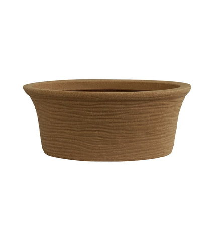 Nora Magnolia Pot in a brown earthy tone roto molded planter pot with a textured marble-like finish and wide shallow profile for plants.