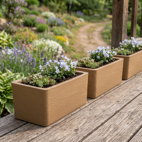 Nora 20-inch rectangular tan planters with wood grain texture, filled with small white flowers on a wooden deck.